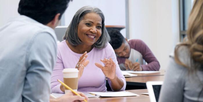 Cheerful adult student participates in study group.